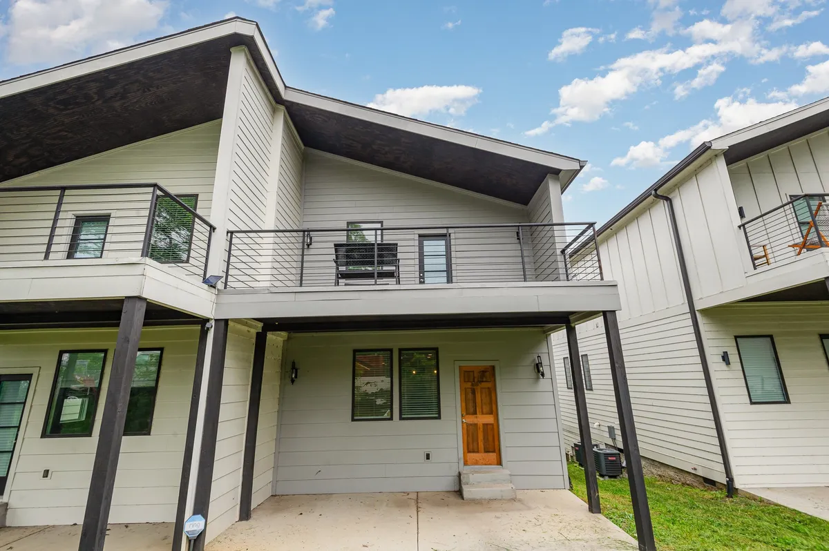 This image features a stylish front door, balcony, and broad stairs, conveying a sense of arrival and the anticipation of setting out for or returning from a group adventure. The balcony and stairs add a social, welcoming touch—suggesting spaces for morning coffee or sunset conversations before or after exploring the neighborhood.